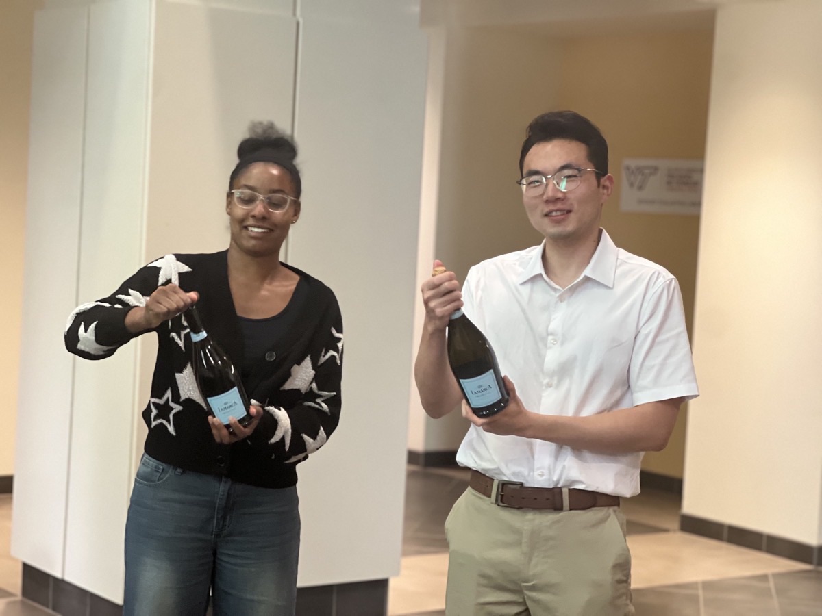 Zane and Dacia celebrating with champagne